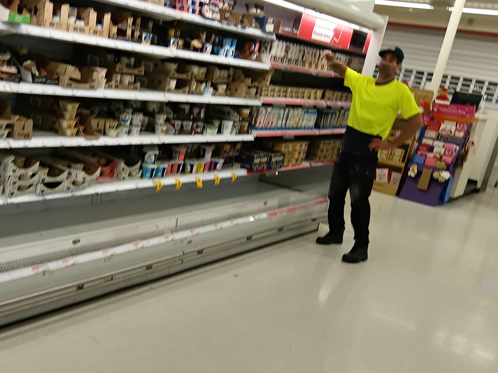 Team member indicating a section of refrigeration units that need to be written up for the supermarket to follow up on
